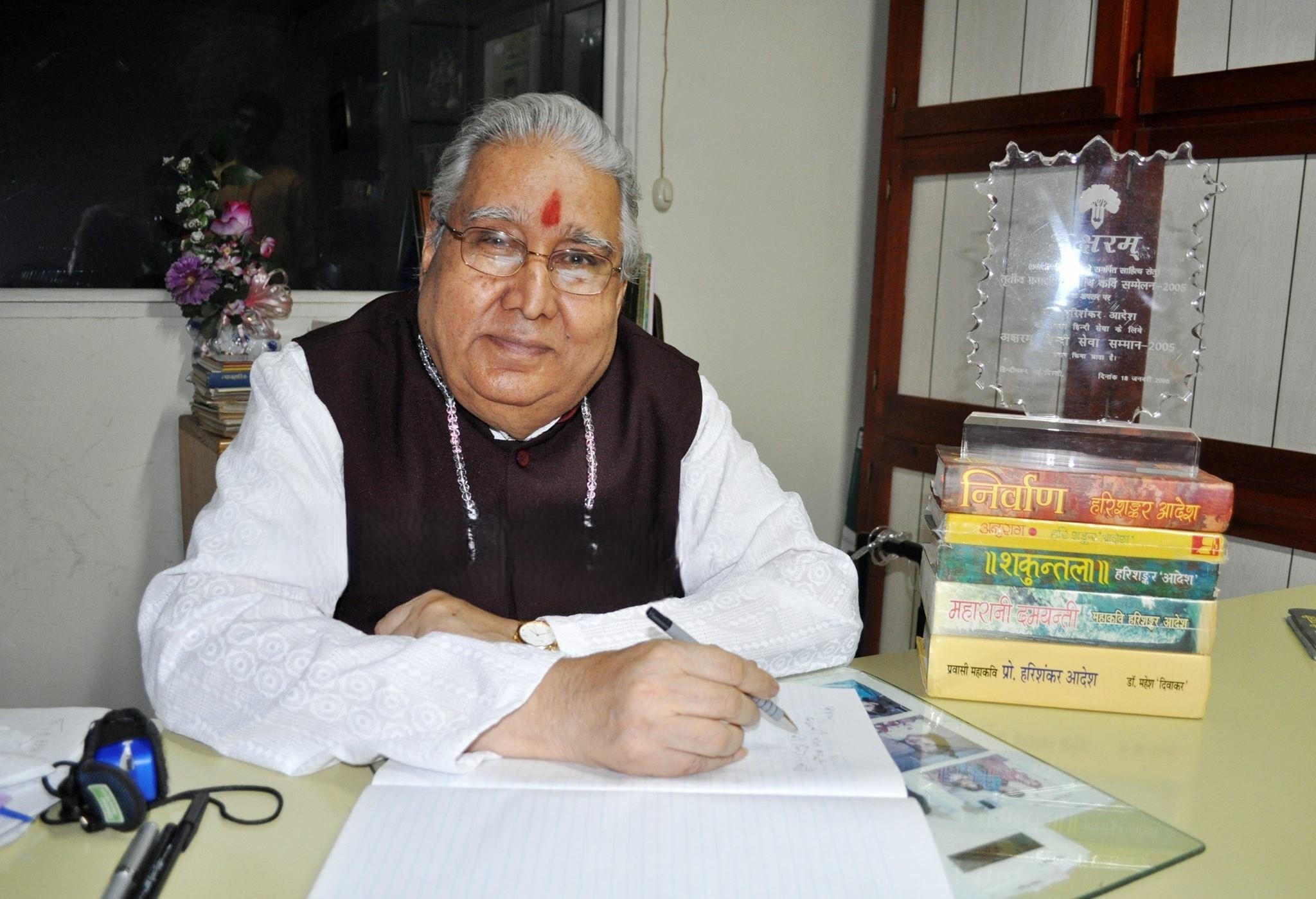 Mahakavi Prof. Hari Shanker Adesh at his writing desk with published epics